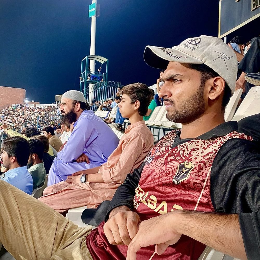 Waleed Ahmad watching a night cricket match from the stands