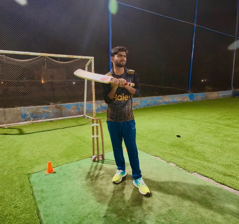 Waleed Ahmad practising cricket in the nets at night