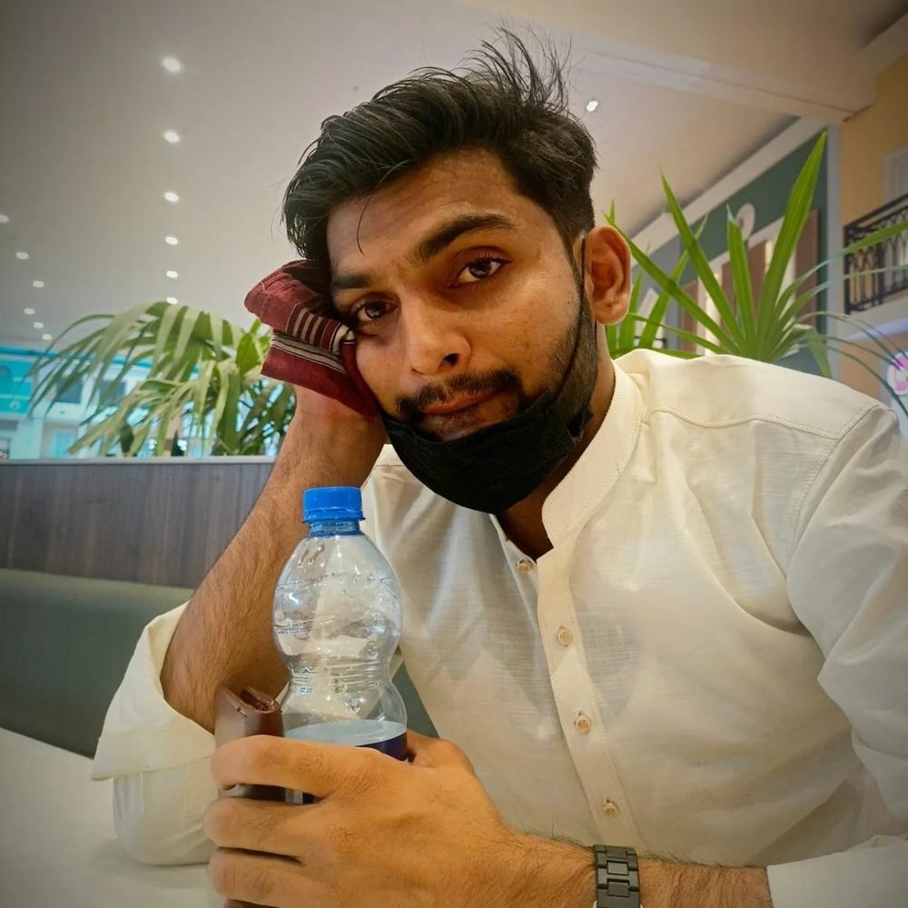 Waleed Ahmad at a cafe table between filming