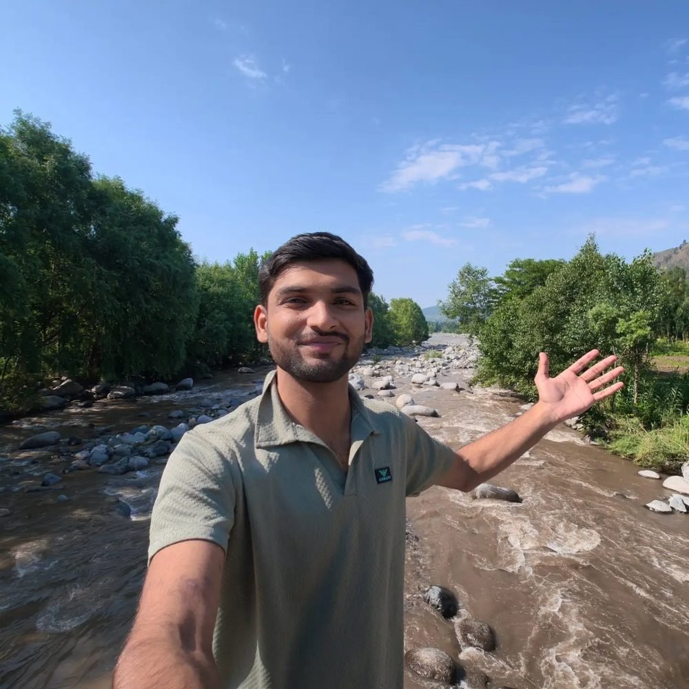 Waleed Ahmad beside a river in the Pakistani mountains