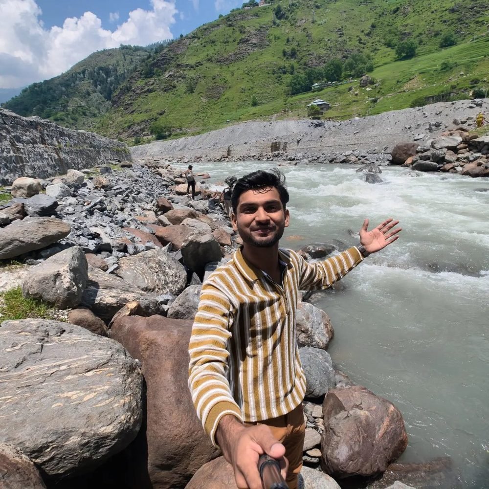Waleed Ahmad by a mountain river, Northern Pakistan